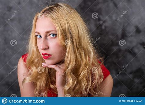 Blonde In A Red Dress Looks Into The Camera Stock Photo Image Of