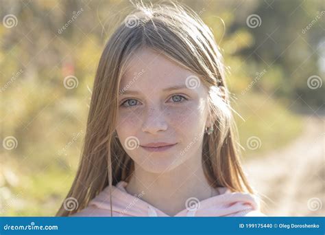 Beautiful Blonde Young Girl With Freckles Outdoors On Nature Background In Autumn Close Up