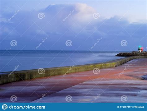 Lighthouses Surrounded By The Sea Under A Cloudy Sky In The Evening