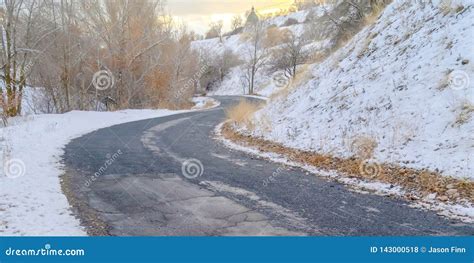 Road Curving Along A Snowy Mountain At Sunset Stock Photo Image Of