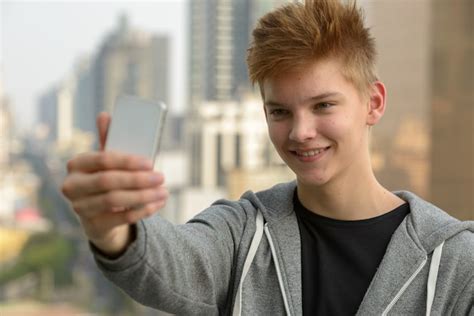 Premium Photo Portrait Of Young Handsome Teenage Boy Against View Of
