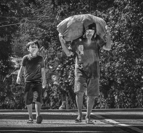 Heavy Burden To Carry A Man And His Son Return From A Rura Flickr