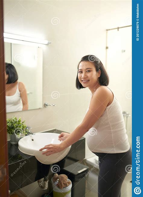Closeup Of Beautiful Young Woman Washing Face In Bathroom Stock Image