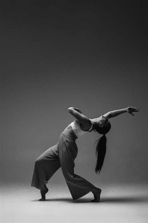 A Woman Is Standing In The Middle Of A Dance Pose