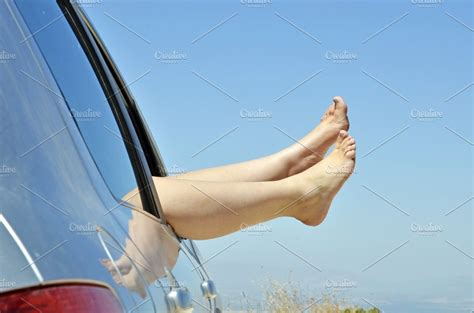 Women With Bare Feet Out The Window High Quality Holiday Stock Photos