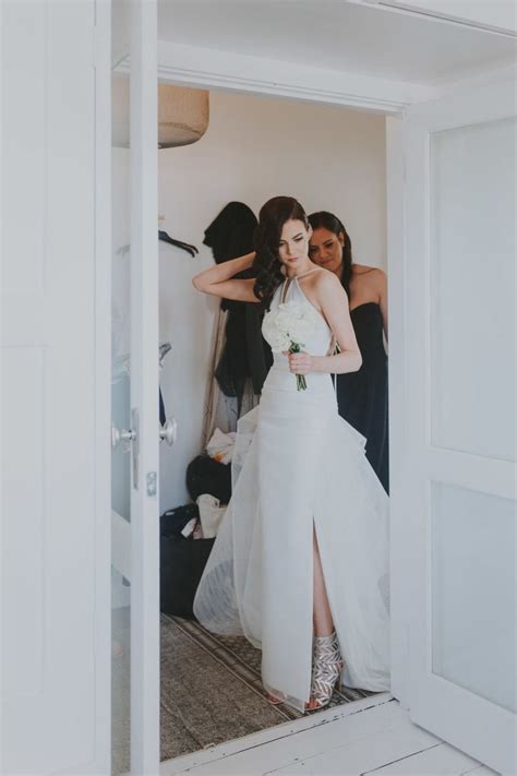 The Bride Is Getting Ready To Walk Down The Aisle In Her Wedding Dress With Her Friends