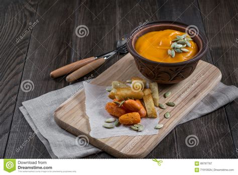 Pumpkin Cream Soup In A Clay Bowl With Snack Fried Croutons Breadbaked
