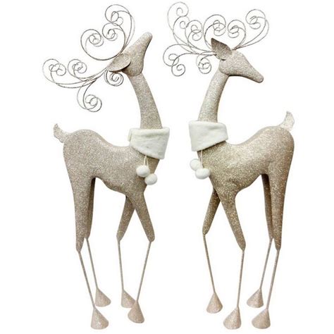 Two Metal Reindeers With Hats And Scarfs On Their Heads