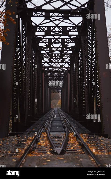 The Train Trestle With Fallen Autumn Leaves On The Train Tracks Stock