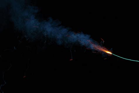 Burning Fuse With Orange Sparks And Blue Smoke Photograph By Lukasz