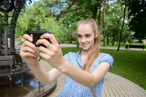 Beautiful Young Blonde Woman Shooting Selfie On Mobile Phone In The Park Stock Image Everypixel
