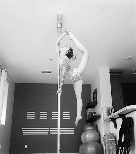 A Woman Is Doing Pole Dancing In Her Room