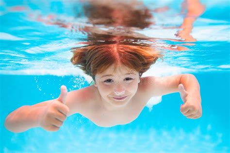 Child Splashing In Swimming Pool Kid Swimming In Pool Underwater