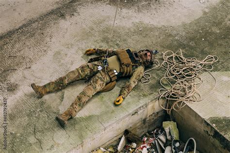 Special Forces Soldier Pretending Dead Showcasing Fall From The Rope