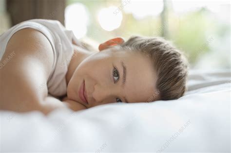 smiling girl laying on bed stock image f013 7530 science photo library