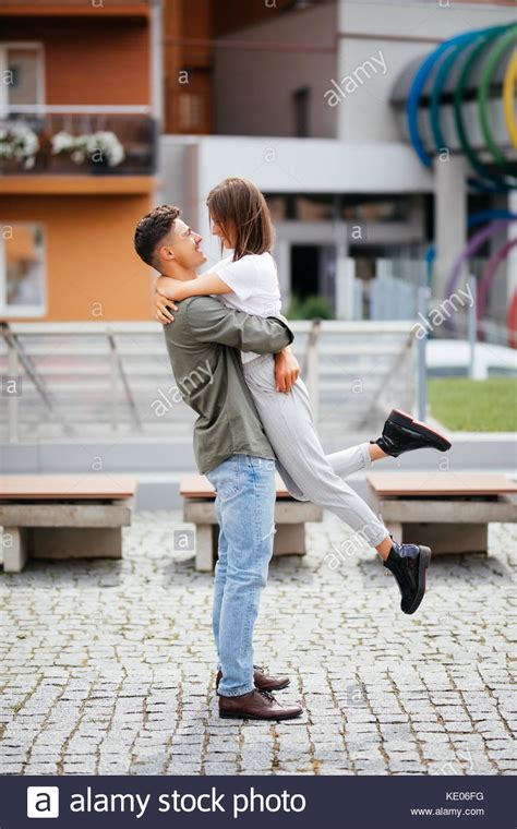 Euphoric Young Couple Meeting And Hugging On The Street Smiling Couple