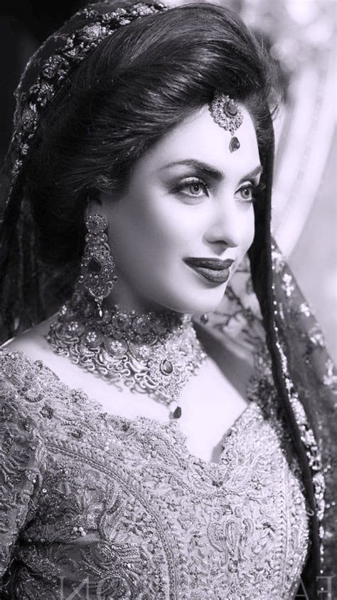 A Woman In A Bridal Dress Posing For The Camera