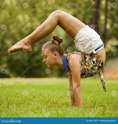 Young Girl Doing Stretching Exercise On Green Stock Image Image Of