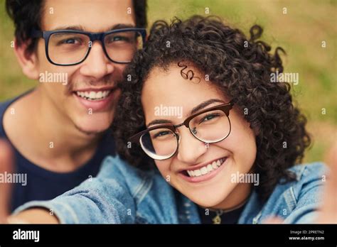 i want to capture all our moments together a teenage couple taking a selfie outdoors stock