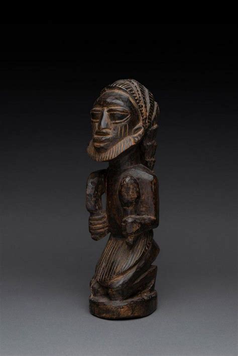 Yoruba Eshu Kneeling Figure In Patinated Wood Figuresgroups