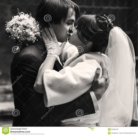 Bride Kisses A Groom While He Hugs Her Tightly Stock Image Image Of