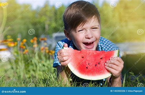 Funny Boy Eats Watermelon Outdoors In Summer Park Stock Photo Image