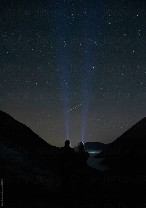Young Couple Watching Shooting Stars In The Mountains Cumbria Uk