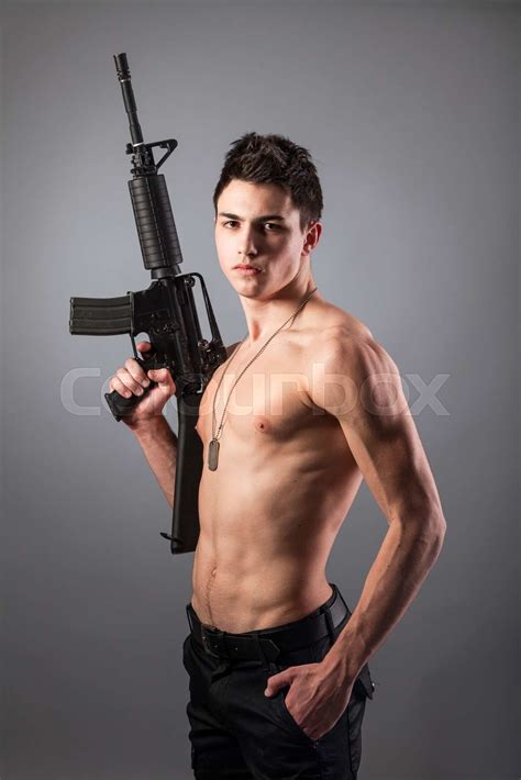 Handsome Bare Chested Soldier Is Holding A Rifle Stock Image Colourbox