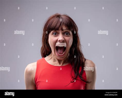 Excited Exuberant Woman Standing Screaming At The Camera With Her Mouth