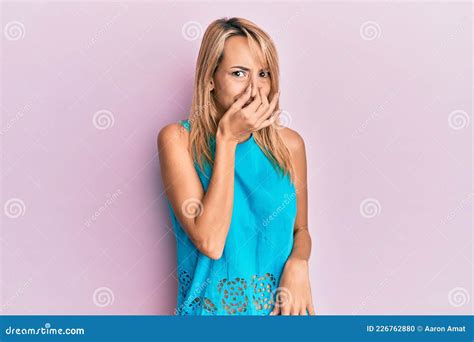 Beautiful Blonde Woman Wearing Casual Clothes Smelling Something Stinky And Disgusting