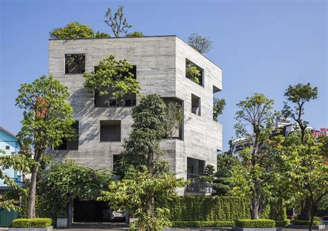 Trees Pop Out Of The Facade Of A Pentagonal Concrete House Designed By