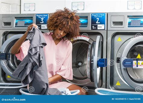 Young Black African American Woman Washing Her Clothes In A Automatic