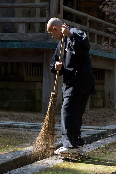 Japan Monk At Temple On Koyasan Sweeps Out A Ditch With A Bamboo