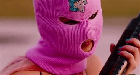 A Person Wearing A Pink Mask And Holding A Hair Dryer In Their Hand