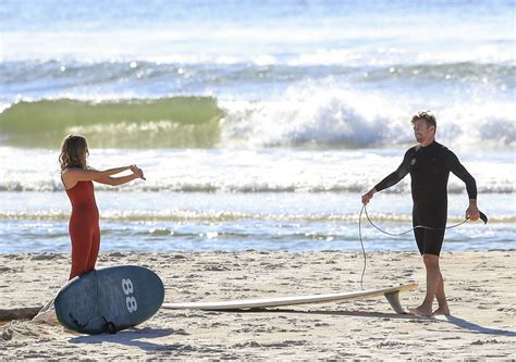 Simon Baker Enjoys A Surf Session With His Girlfriend Laura May Gibbs