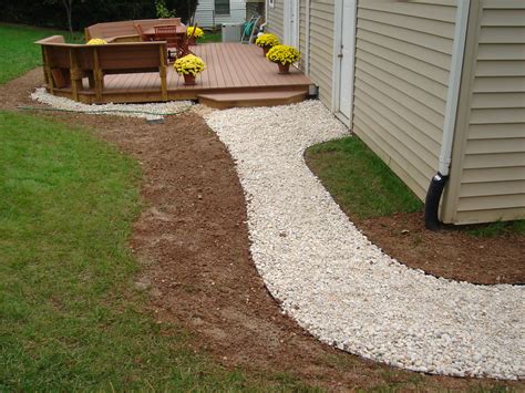 Yard and drainage solutions to resolve standing water after it rains, flooding window wells, and water near the foundation. This gravel-based #walkway is cost-effective and easy to repair. Click on the picture to learn ...