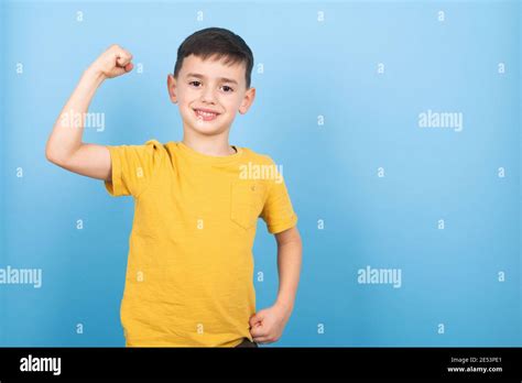 Portrait Of Cute Kid Boy Showing The Muscle Of His Arm Power Boy Stock