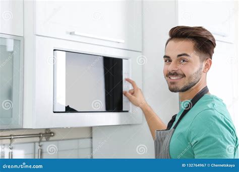 Young Man Using Modern Microwave Oven Stock Image Image Of Happy