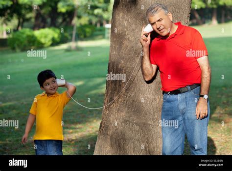 Grandfather And Grandson Talking Through Paper Cups Stock Photo Alamy