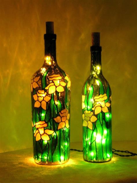 Two Green Glass Bottles With Lights In Them