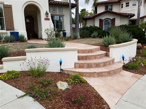 Front Entry With Low Wall Stucco Wall And Curved Flagstone Walkway With