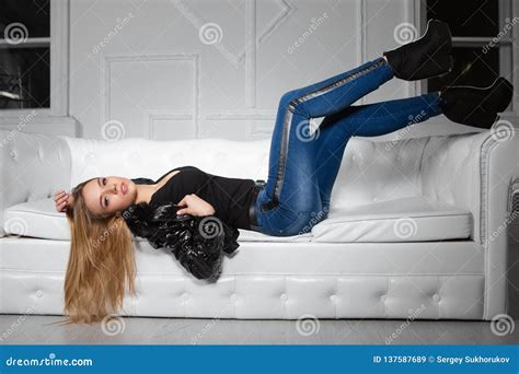 Alluring Woman Posing Lying On A Sofa Stock Image Image Of Jeans Lies 137587689