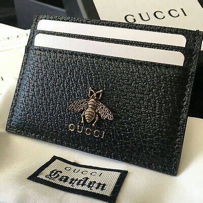 Men's gucci wallet gucci made in italy stamped inside famous colours hold a number of cards no slots and holes a small amount of change lovely wallet can collect in person or bank transfer post royal mail first class signed for tracked. (Sponsored)eBay - AUTHENTIC GUCCI GG CARD HOLDER BLACK BEE ...
