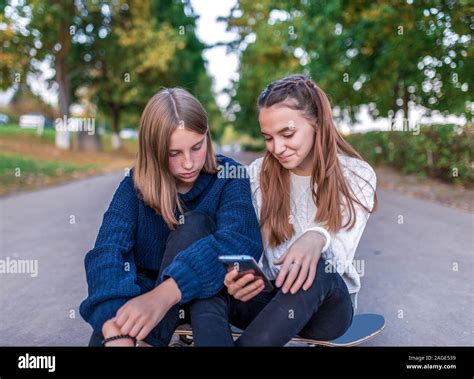 2 girls girlfriends, happy sitting smiling, teenagers after school