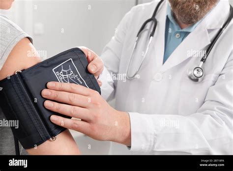 Doctor Checking Blood Pressure Of Patient In Hospital Stock Photo Alamy