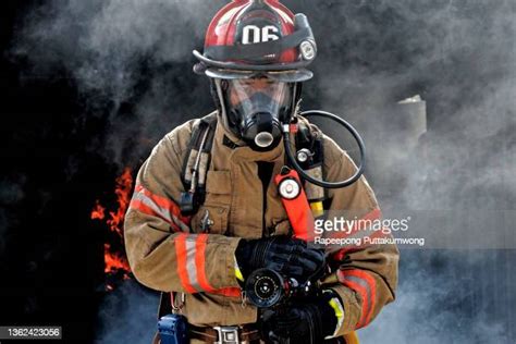 Male Fireman Holding Hose Photos And Premium High Res Pictures Getty