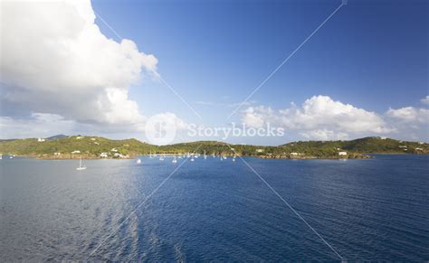 White Sailboats Along A Tropical Coast Royalty Free Stock Image