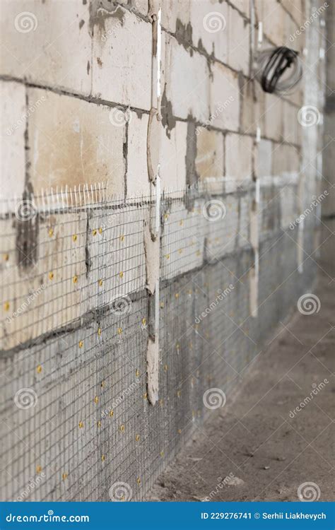 Concrete Wall Filled With Wire Mesh For Further Plastering Stock Image