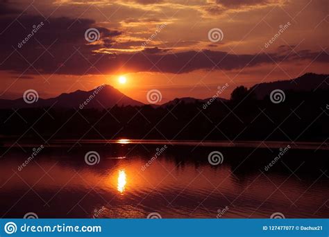 A Beautiful Colorful Sunset Over The Mountains Lake And Forest In