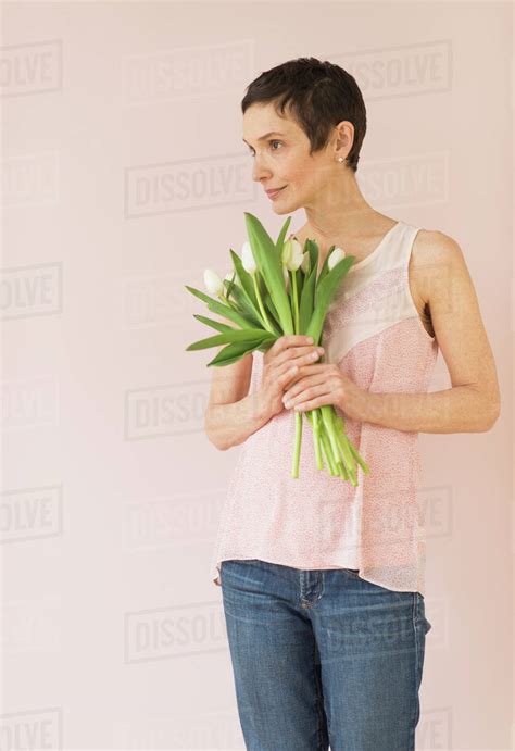 Portrait Of Mature Woman With Tulips Stock Photo Dissolve